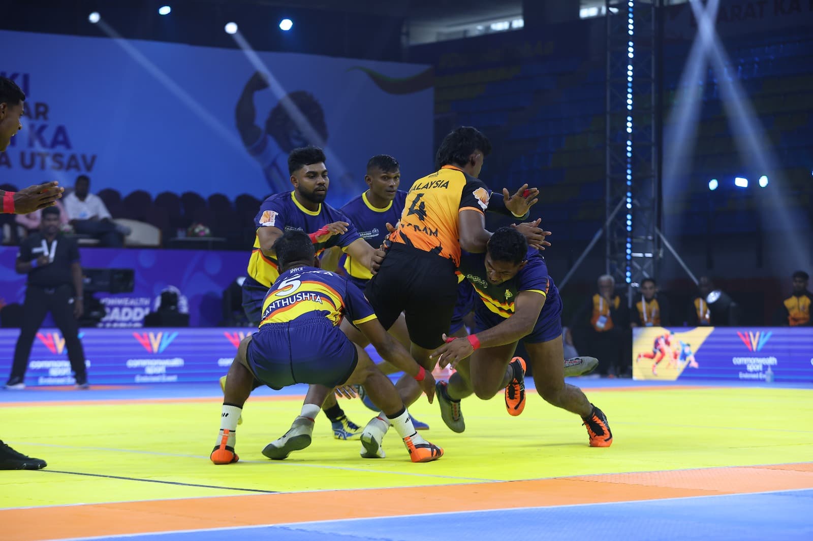 Sri Lanka's defenders tackle a Malaysia raider at the Commonwealth Kabaddi Championship in Ahmedabad