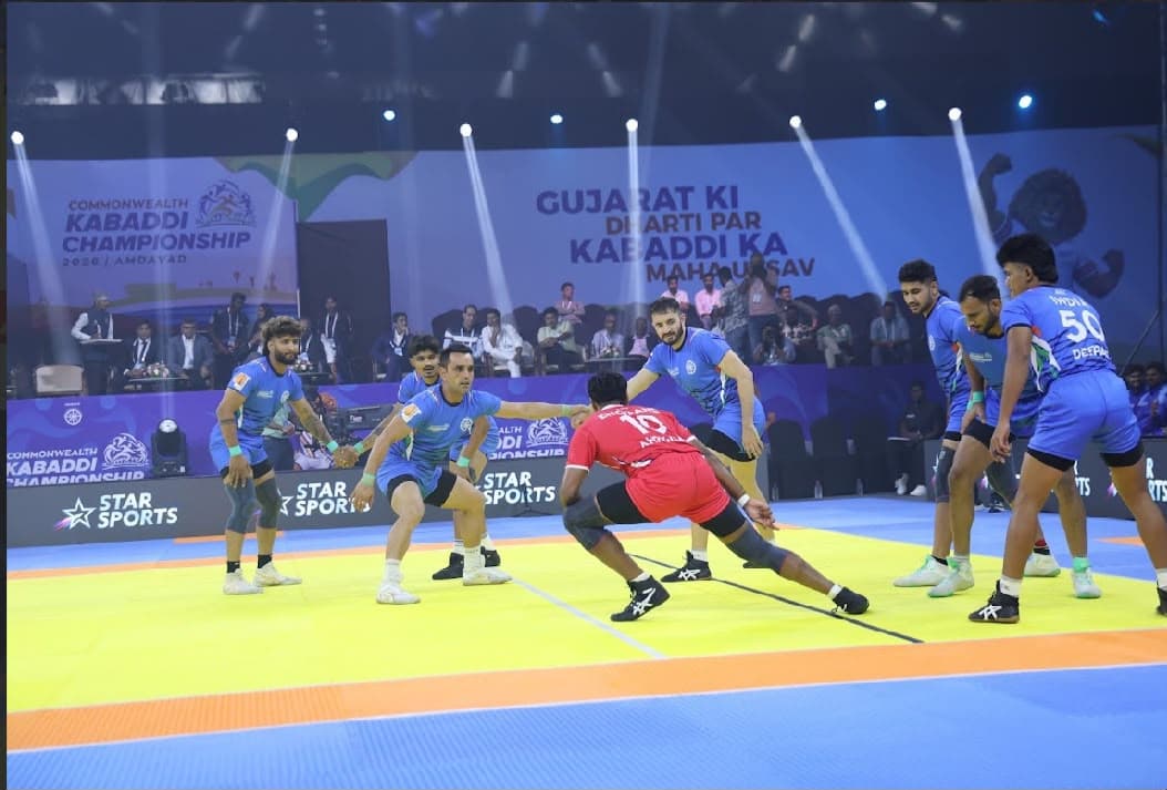 India's men close in on an England raider at the Commonwealth Kabaddi Championship in Ahmedabad