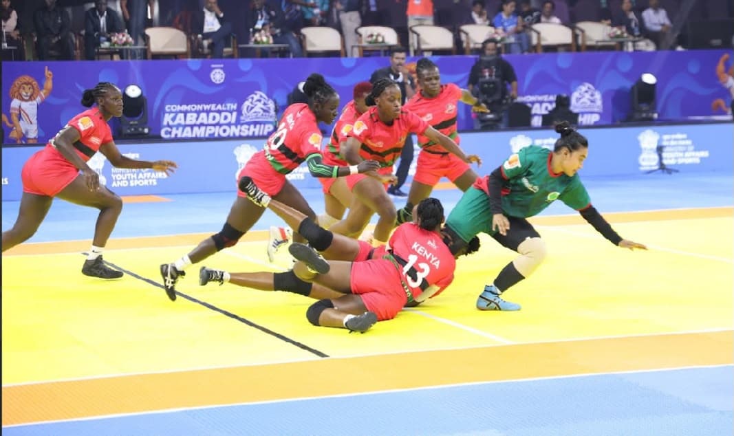 Kenya's women's defenders tackle a Bangladesh raider at the Commonwealth Kabaddi Championship in Ahmedabad